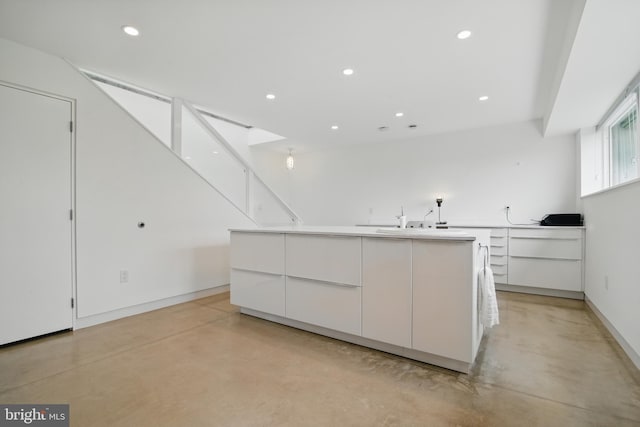 317 Clearview Ave, Nazareth, PA 18064 - kitchen with concrete floors, modern cabinets, white cabinetry, a large island, and recessed lighting