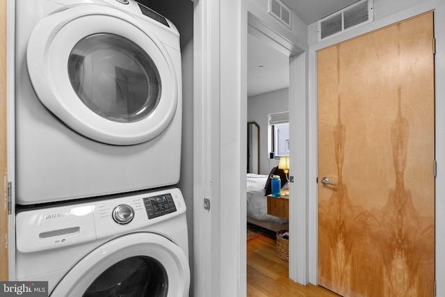 1800 S 16th St Unit B, Philadelphia, PA 19145 - laundry area with stacked washer / drying machine and wood finished floors