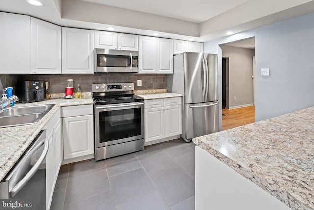 94 E Oak Ave, Lawnside, NJ 08045 - kitchen featuring stainless steel appliances, recessed lighting, white cabinets, backsplash, and light tile patterned floors
