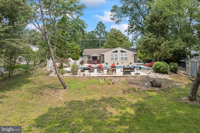 94 E Oak Ave, Lawnside, NJ 08045 - rear view of house with an outdoor living space, a patio, a yard, a storage unit, and a pool