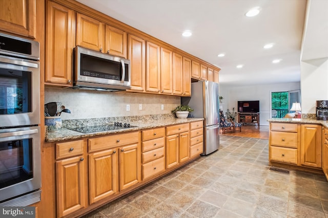 3010 Phyllmar Pl, Oakton, VA 22124 - kitchen with appliances with stainless steel finishes, tasteful backsplash, recessed lighting, light stone counters, and light stone finish floors