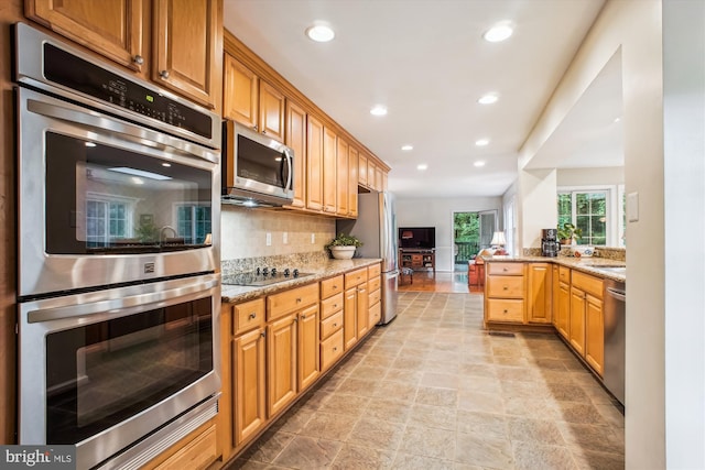 3010 Phyllmar Pl, Oakton, VA 22124 - kitchen with stainless steel appliances, recessed lighting, decorative backsplash, light stone countertops, and light stone finish flooring