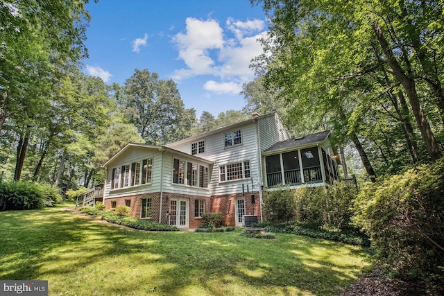 3010 Phyllmar Pl, Oakton, VA 22124 - rear view of house with a sunroom, a lawn, brick siding, and stairs