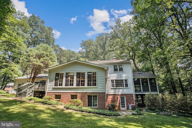 3010 Phyllmar Pl, Oakton, VA 22124 - back of property with a sunroom, a yard, a chimney, and brick siding