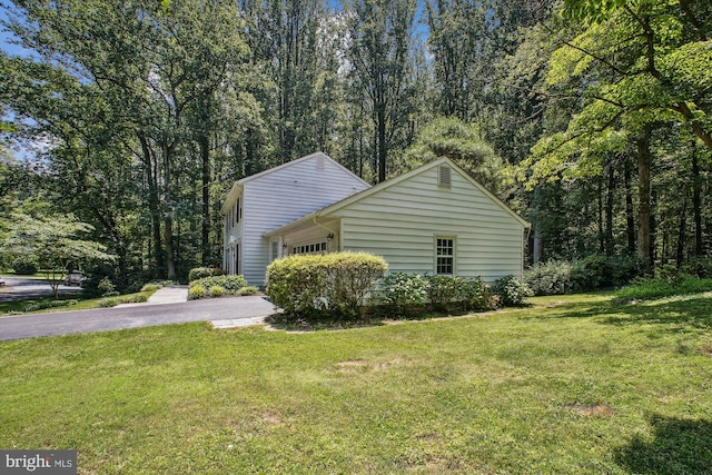 3010 Phyllmar Pl, Oakton, VA 22124 - view of side of home featuring an attached garage, asphalt driveway, and a lawn