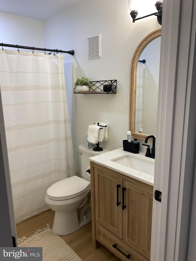 35979 Condo Dr Unit 203B, Rehoboth Beach, DE 19971 - bathroom featuring wood finished floors, vanity, and a shower with shower curtain