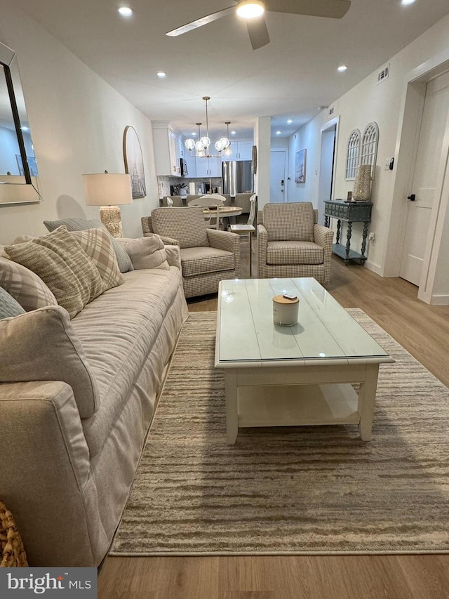 35979 Condo Dr Unit 203B, Rehoboth Beach, DE 19971 - living area featuring ceiling fan, wood finished floors, recessed lighting, and a chandelier
