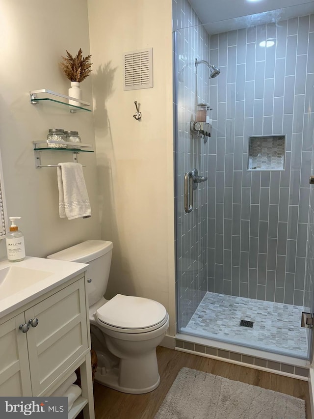 35979 Condo Dr Unit 203B, Rehoboth Beach, DE 19971 - full bathroom with wood finished floors, a stall shower, and vanity