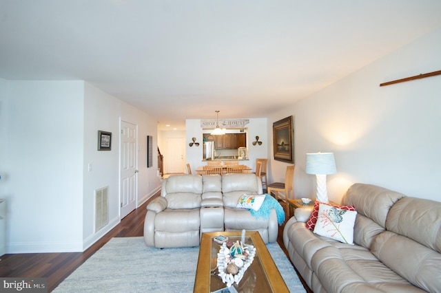 101 Main St Unit 115, Secretary, MD 21664 - living area with dark wood-type flooring and a chandelier