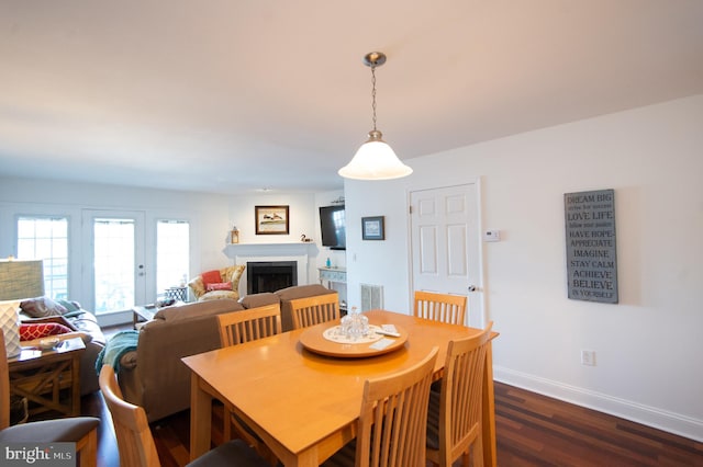101 Main St Unit 115, Secretary, MD 21664 - dining space featuring dark wood-style floors and a fireplace