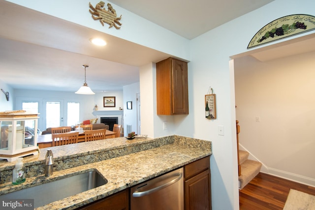 101 Main St Unit 115, Secretary, MD 21664 - kitchen with dishwasher, wood finished floors, light stone counters, a fireplace, and open floor plan