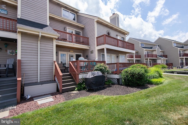 101 Main St Unit 115, Secretary, MD 21664 - rear view of house with a lawn, a chimney, a deck, and a residential view