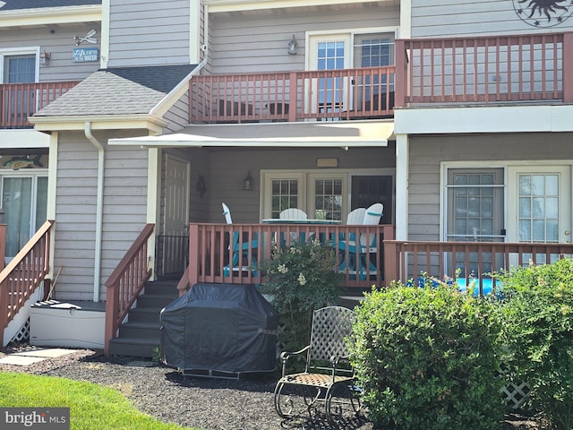 101 Main St Unit 115, Secretary, MD 21664 - rear view of house featuring a balcony and roof with shingles