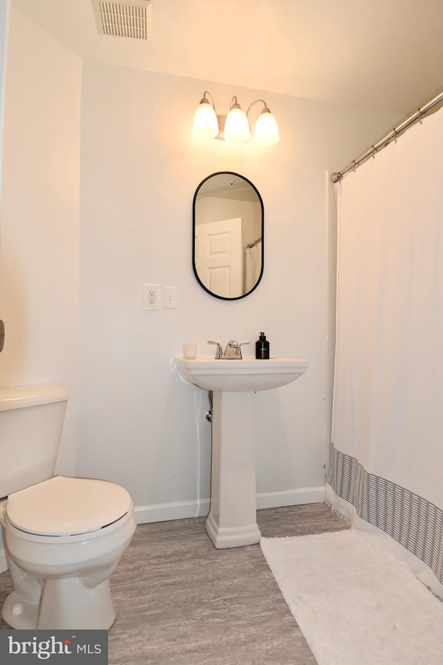 3166 Freestone Ct, Abingdon, MD 21009 - bathroom with wood finished floors and a shower with curtain