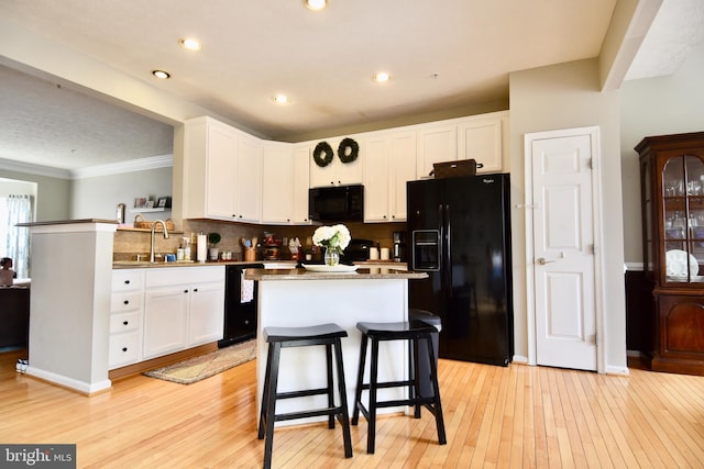 3166 Freestone Ct, Abingdon, MD 21009 - kitchen with black appliances, light wood-type flooring, white cabinets, tasteful backsplash, and crown molding