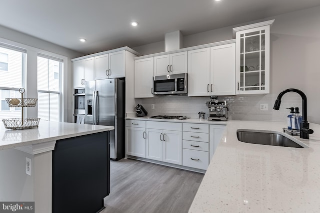 7282 Nittany Ln, Alexandria, VA 22306 - kitchen with appliances with stainless steel finishes, decorative backsplash, white cabinetry, light stone countertops, and recessed lighting