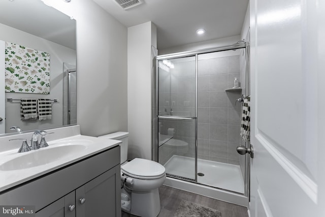 7282 Nittany Ln, Alexandria, VA 22306 - full bathroom featuring vanity, wood finished floors, a stall shower, and recessed lighting