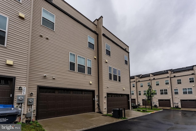 7282 Nittany Ln, Alexandria, VA 22306 - exterior space with an attached garage and a cooling unit