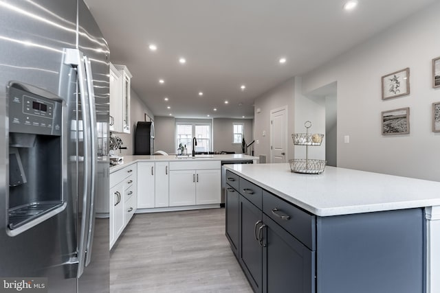 7282 Nittany Ln, Alexandria, VA 22306 - kitchen with stainless steel appliances, a peninsula, recessed lighting, light countertops, and white cabinets