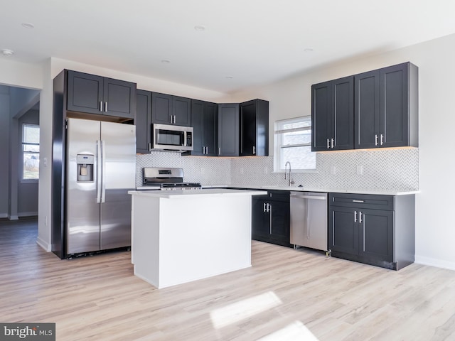 1016 Huntington Ave, Glendora, NJ 08029 - kitchen with stainless steel appliances, light wood-style floors, backsplash, and a center island
