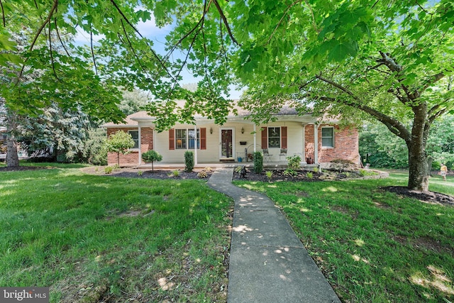 136 Main St, Red Hill, PA 18076 - ranch-style house with brick siding, covered porch, and a front lawn