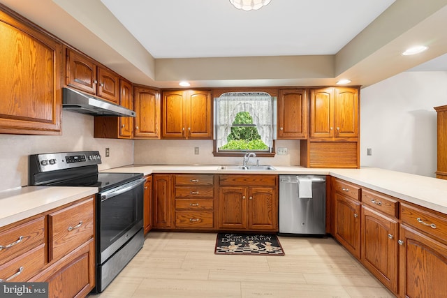 136 Main St, Red Hill, PA 18076 - kitchen with appliances with stainless steel finishes, under cabinet range hood, brown cabinetry, recessed lighting, and light countertops