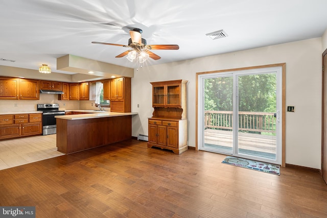 136 Main St, Red Hill, PA 18076 - kitchen with electric range, brown cabinets, a peninsula, light countertops, and ceiling fan
