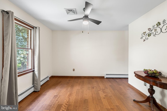 136 Main St, Red Hill, PA 18076 - spare room with baseboard heating, wood finished floors, and ceiling fan