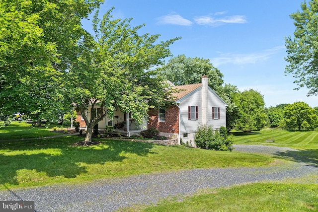136 Main St, Red Hill, PA 18076 - obstructed view of property featuring a front yard, a chimney, and gravel driveway