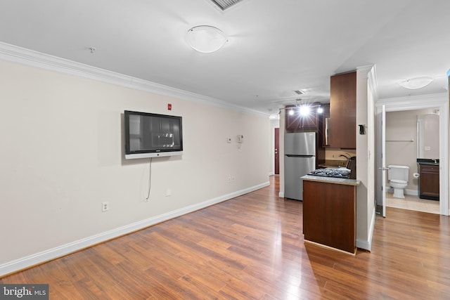 1210 R St NW Unit B1, Washington, DC 20009 - kitchen with freestanding refrigerator, crown molding, wood finished floors, and light countertops