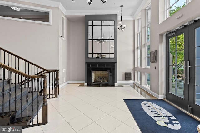 1210 R St NW Unit B1, Washington, DC 20009 - foyer featuring a chandelier, tile patterned flooring, crown molding, a fireplace, and a high ceiling