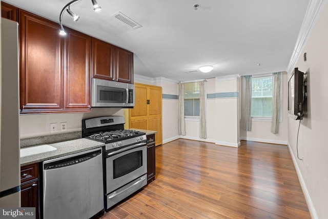 1210 R St NW Unit B1, Washington, DC 20009 - kitchen with stainless steel appliances, ornamental molding, wood finished floors, and light stone countertops
