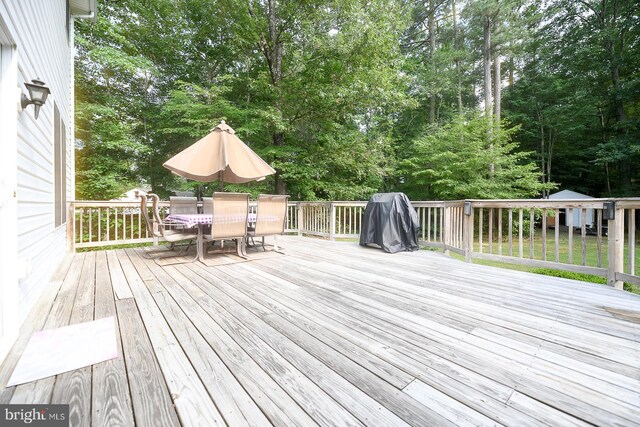 21481 Indian Bridge Rd, California, MD 20619 - wooden deck with outdoor dining area and view of scattered trees