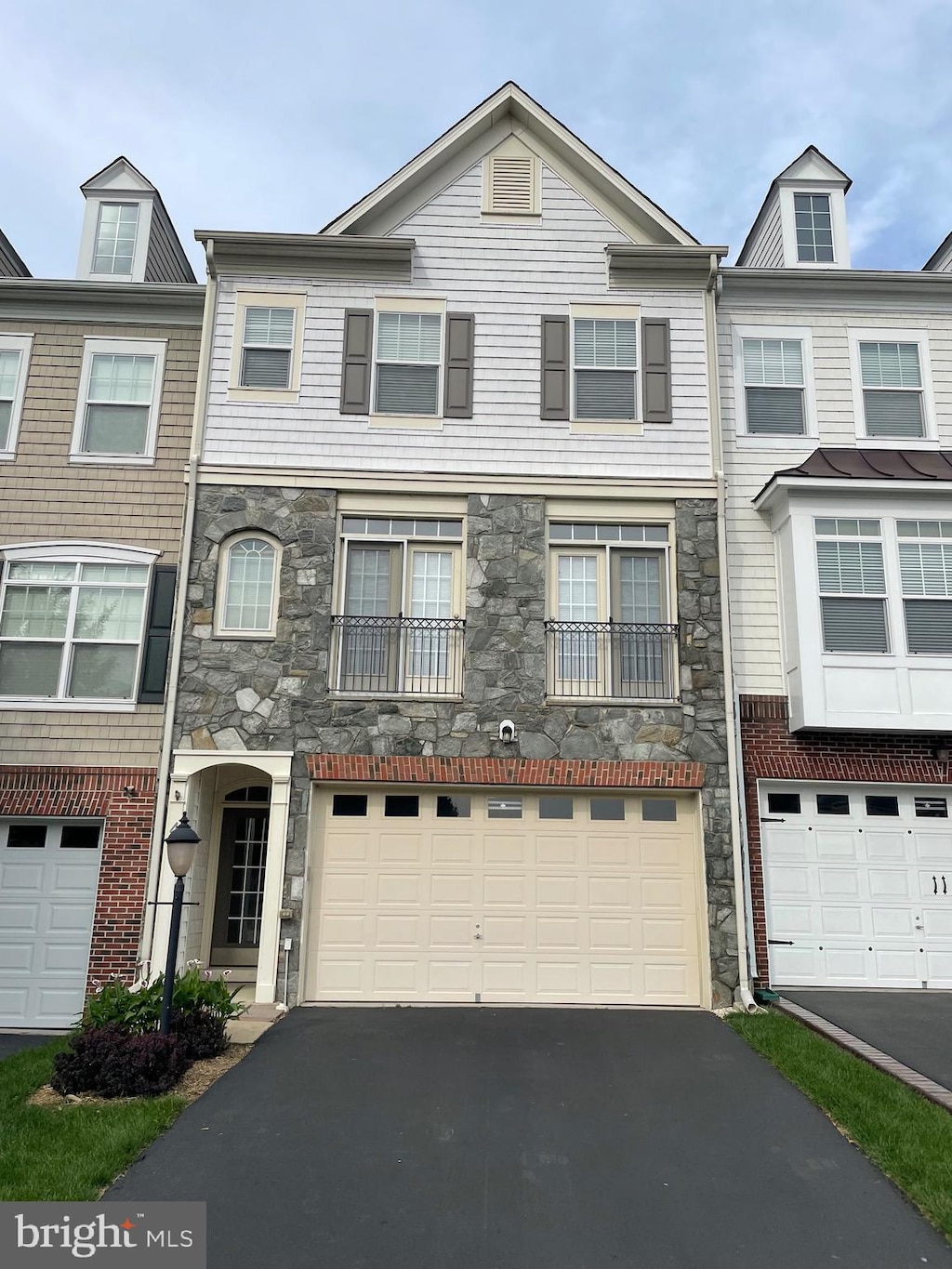 42 Pike Pl, Stafford, VA 22556 - view of property featuring stone siding, asphalt driveway, and an attached garage