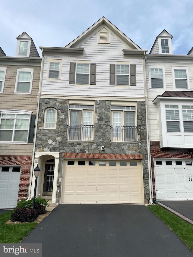 42 Pike Pl, Stafford, VA 22556 - view of property featuring stone siding, asphalt driveway, and an attached garage