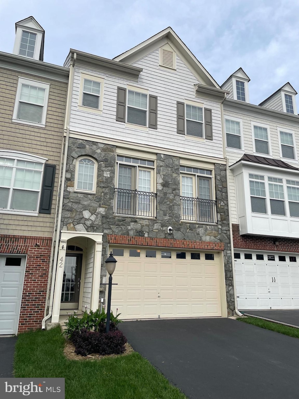 42 Pike Pl, Stafford, VA 22556 - townhome / multi-family property featuring stone siding, driveway, and an attached garage