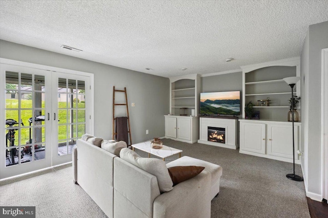 29 Twin Brooks Dr, Willow Grove, PA 19090 - living area with french doors, carpet floors, a textured ceiling, a glass covered fireplace, and built in features