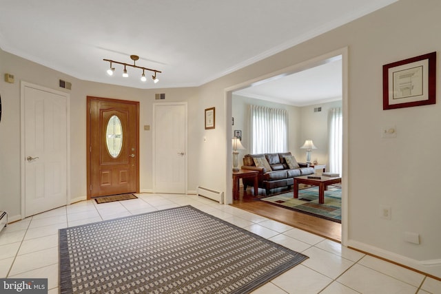 500 S Lexington St, Arlington, VA 22204 - foyer entrance featuring light tile patterned floors, a baseboard radiator, and crown molding