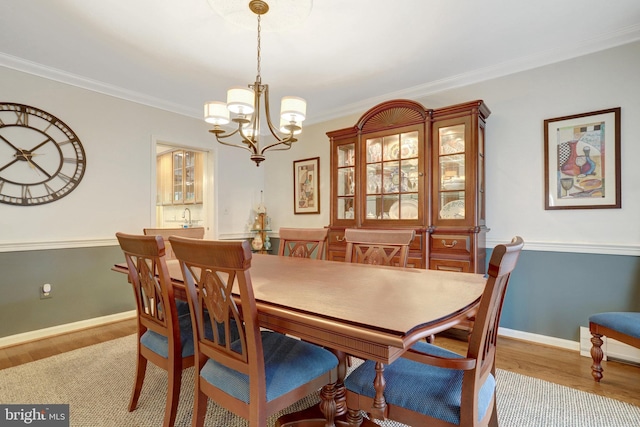 500 S Lexington St, Arlington, VA 22204 - dining space featuring wood finished floors, a chandelier, and ornamental molding