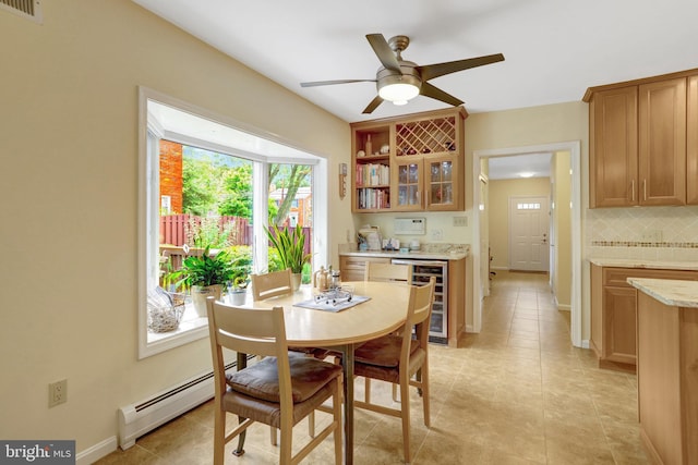 500 S Lexington St, Arlington, VA 22204 - dining room with beverage cooler, a baseboard heating unit, a ceiling fan, bar, and light tile patterned floors