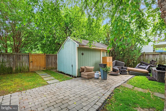 411 E Bellefonte Ave, Alexandria, VA 22301 - fenced backyard with a patio, an outdoor structure, and a gate