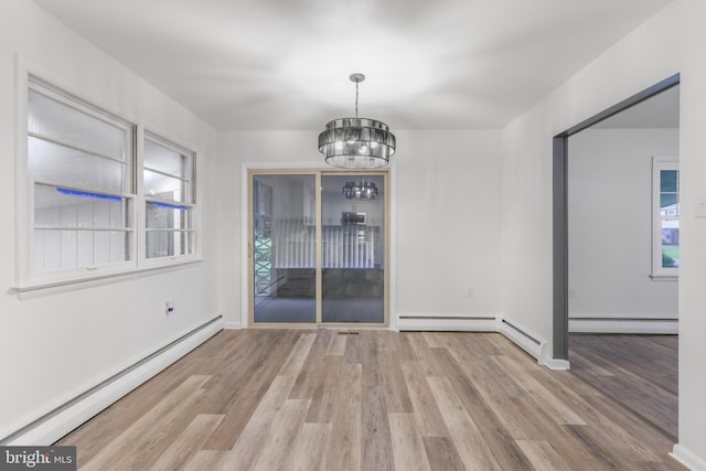 708 S Broad St, Mechanicsburg, PA 17055 - unfurnished dining area with a baseboard heating unit, a baseboard radiator, a chandelier, and wood finished floors
