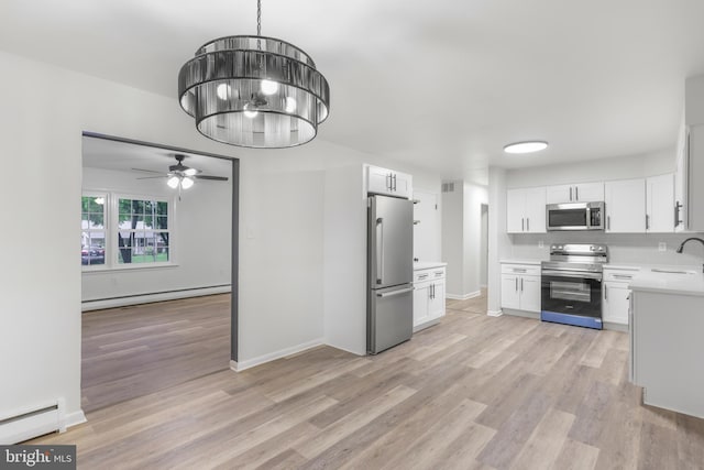 708 S Broad St, Mechanicsburg, PA 17055 - kitchen featuring stainless steel appliances, light countertops, a ceiling fan, and light wood-type flooring