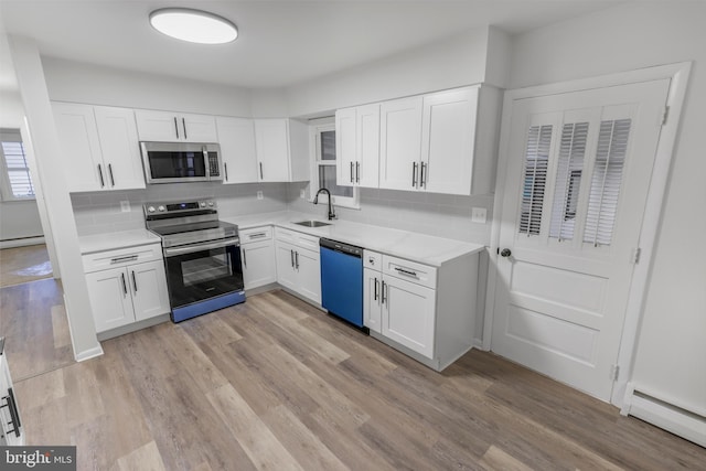 708 S Broad St, Mechanicsburg, PA 17055 - kitchen featuring stainless steel appliances, baseboard heating, light countertops, and tasteful backsplash