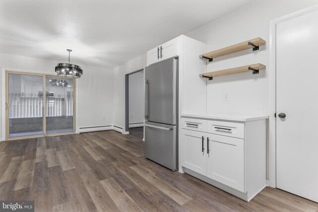 708 S Broad St, Mechanicsburg, PA 17055 - kitchen with freestanding refrigerator, dark wood-style floors, a baseboard heating unit, light countertops, and white cabinets