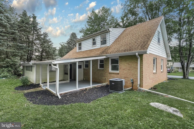 708 S Broad St, Mechanicsburg, PA 17055 - rear view of house featuring brick siding, a patio, a lawn, and a shingled roof