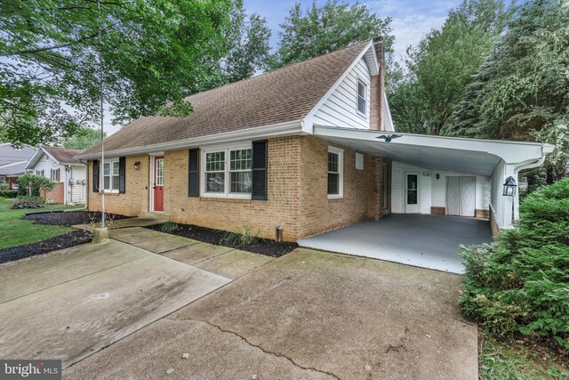 708 S Broad St, Mechanicsburg, PA 17055 - view of front of home featuring concrete driveway, brick siding, a carport, a shingled roof, and a chimney