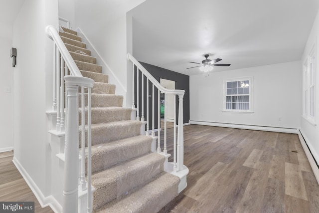 708 S Broad St, Mechanicsburg, PA 17055 - entrance foyer with baseboard heating, stairway, a ceiling fan, and wood finished floors