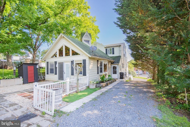 121 E James St, Winchester, VA 22601 - view of front of property featuring a shed, a shingled roof, and gravel driveway