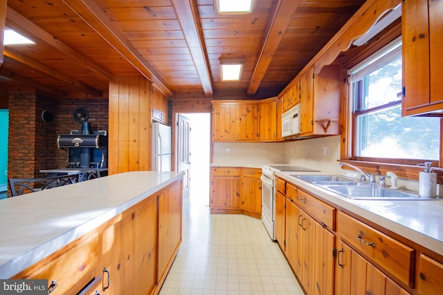 121 E James St, Winchester, VA 22601 - kitchen featuring white appliances, light flooring, a wood stove, light countertops, and a wooden ceiling with exposed beams